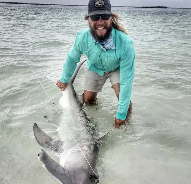 captain craig clopper with hammerhead shark